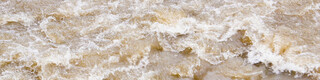 Fluss mit Hochwasser, Überschwemmung bei Unwetter