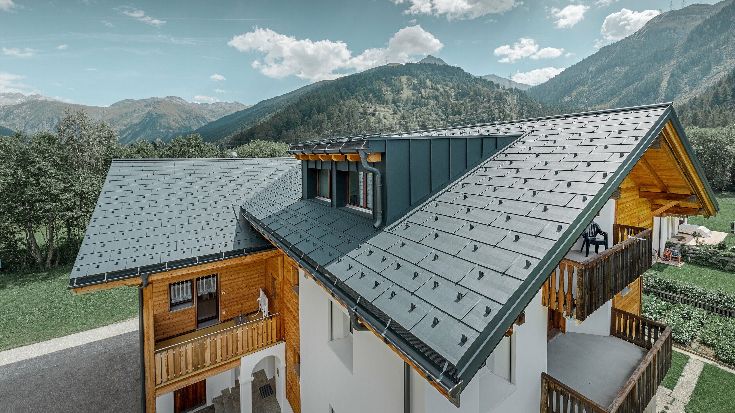 Mehrfamilienhaus Sanierung mit Dachpaneel FX.12 in P.10 Anthrazit Neu saniertes Wohnhaus mit Satteldach und Gaube; Die Dachsanierung wurde mit dem PREFA Dachpaneel FX.12 in Anthrazit durchgeführt.