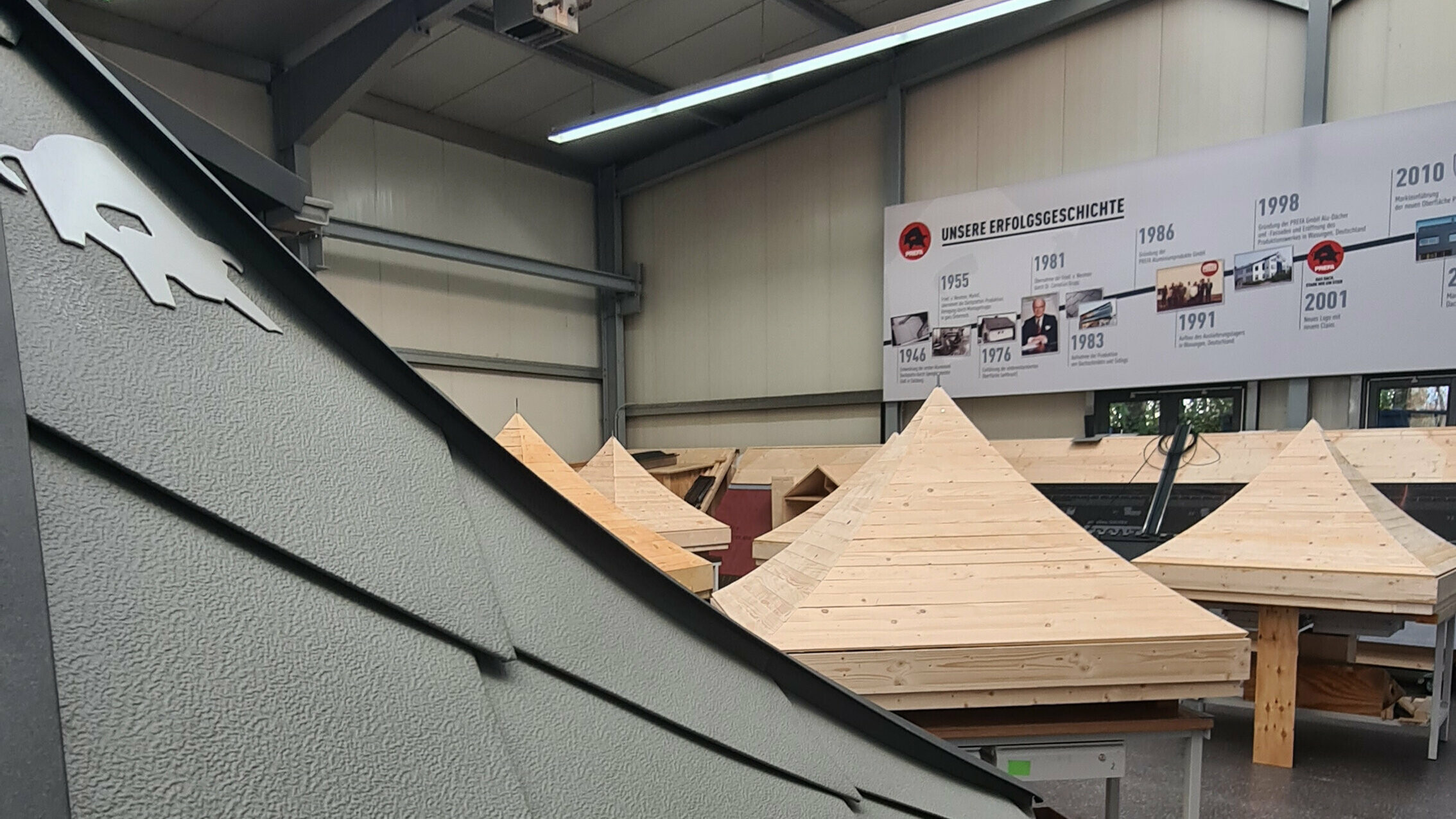 Ein fertiges PREFA Dachmodell vor den noch leeren Holzdächern bei der Klempnermeisterschaft in Hamburg. 