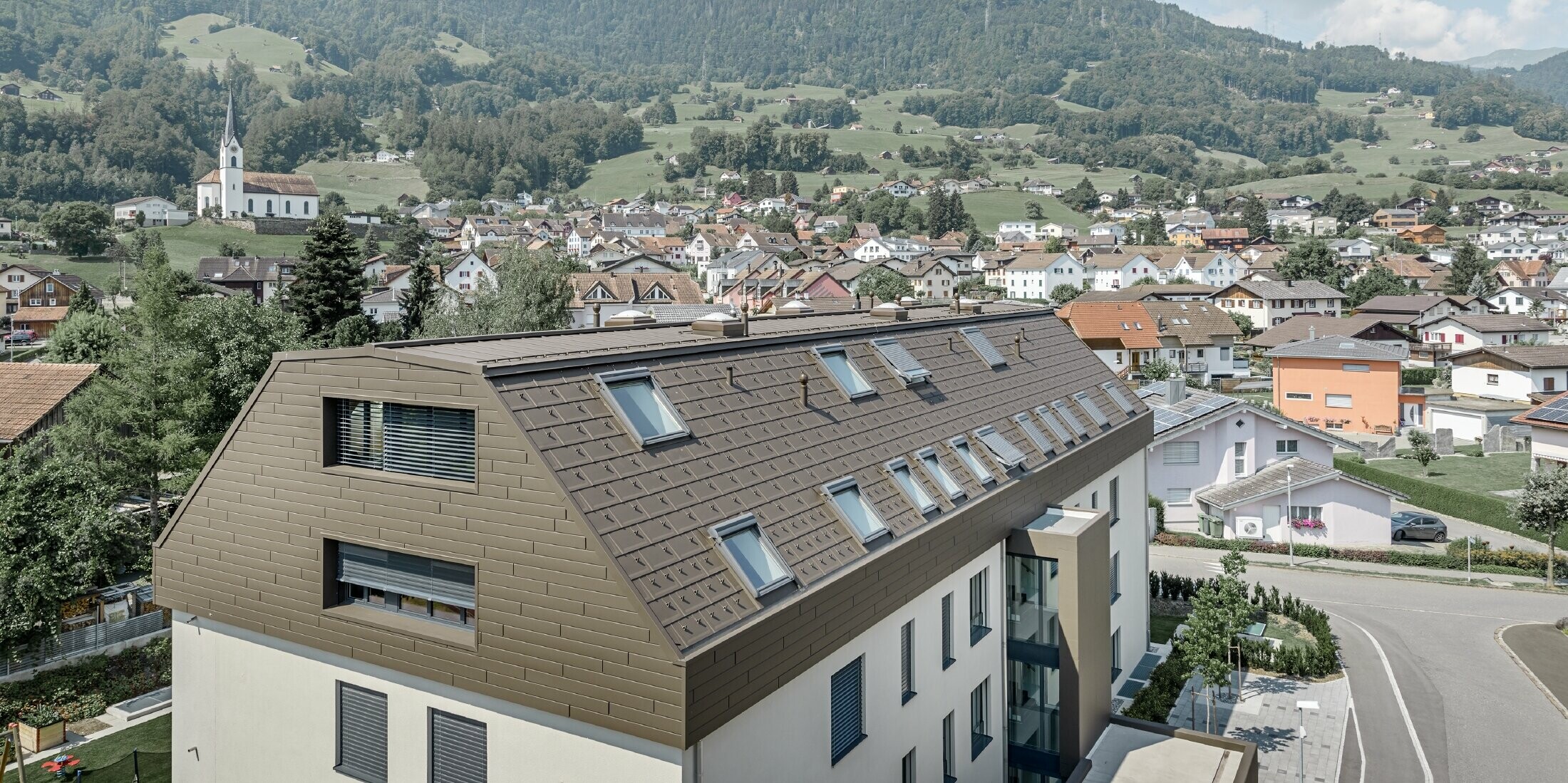 Dachgeschoßausbau des Wohnhauses in Wangs mit braunen Alu-Paneelen von PREFA für Dach und Fassade.
