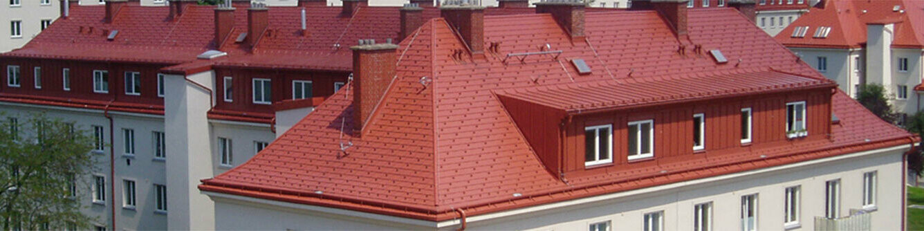 Saniertes Dach mit PREFA Dachschindel in Kupferbraun auf Gemeindebau in Wien 